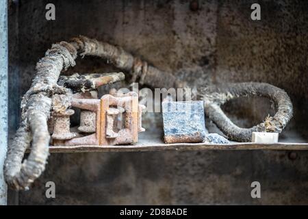 Old towing cable lying on a shelf in an abandoned workshop Stock Photo