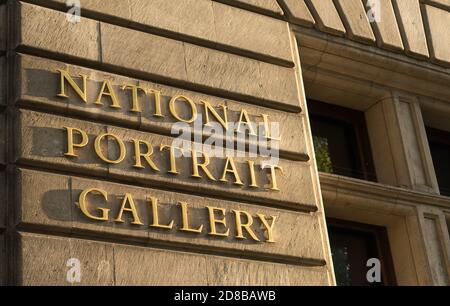 The National Portrait Gallery gold sign on stone wall. London