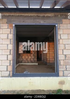 Black thermal insulation frame for window installation in house at construction site Stock Photo