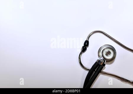 A fragment of a medical stethoscope, two ends stacked on top of each other from the lower right corner.  Stock Photo