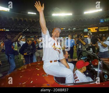 St. Louis slugger Mark McGwire waves to fans while riding a vintage Corvette after hitting his 62nd home run during a major league baseball game against the Chicago Cubs on September 8, 1998 in St. Louis. That home run broke Roger Maris’s record for home runs during a single season. Photo by Francis Specker Stock Photo