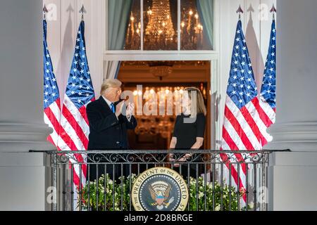 President Donald J. Trump applauds U.S. Supreme Court Associate Justice Amy Coney Barrett from the Blue Room Balcony of the White House Monday, October 26, 2020, after attending Justice Barrett’s swearing-in ceremony on the South Lawn. (USA) Stock Photo