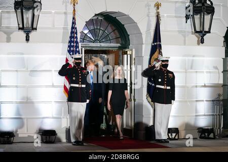 President Donald J. Trump, Judge Amy Coney Barrett, and Supreme Court Associate Justice Clarence Thomas arrive to Barrett’s swearing-in ceremony as Supreme Court Associate Justice Monday, October 26, 2020, on the South Lawn of the White House. (USA) Stock Photo
