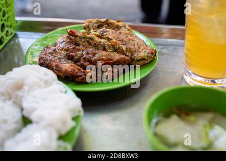 Hanoi, Vietnam. 23rd Oct, 2020. The worm omelette is usually served with rice noodles, a sweet and sour fish sauce and a glass of iced tea. On Hang Chieu Street in the Old Quarter of Hanoi, which is also popular with tourists, the egg dish called 'Cha Ruoi' is sold as street food. (to dpa 'Worm omelette' - Vietnam's slipperiest treat') Credit: Chris Humphrey/dpa/Alamy Live News Stock Photo