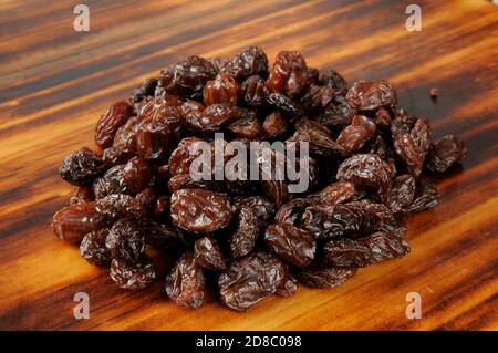 A mound of fresh organic raisins on a cutting board Stock Photo