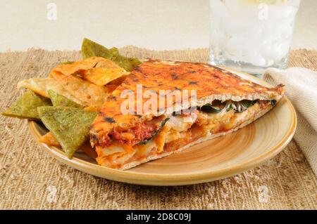Chipotle chicken panini on flatbread with vegetable tortilla chips Stock Photo