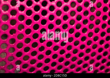 Texture metallic painted with pink glossy paint with black holes-glamorous triphofobia Stock Photo