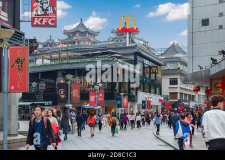 McDonalds restaurant at Shenzhen street in Chinese traditional building style.  Photo with blur in motion.  Shenzhen, China, 2018-03-08. Stock Photo