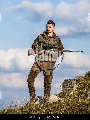 The man is on the hunt. Hunt hunting rifle. Hunter man. Hunting period. Male with a gun. Hunter with hunting gun and hunting form to hunt Stock Photo