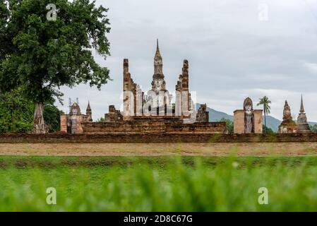 The scenery of Wat Mahathat temple on a cloudy day in the rainy season at Sukhothai province, Thailand. Stock Photo