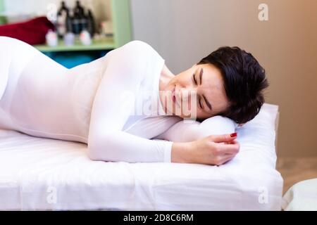A female masseur gives an LPG massage to an attractive woman in a