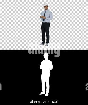 Man in helmet and formal clothes walking looking around and maki Stock Photo