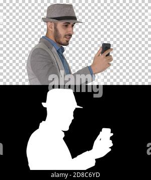 Arabic attractive man in casual clothes recording video for blog Stock Photo