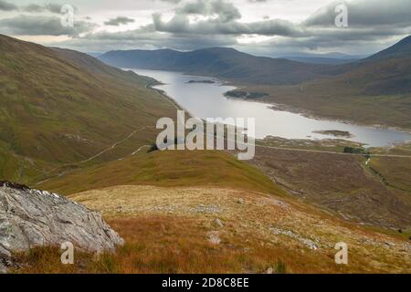 Looking down to Loch Cluanie and the A87 with Beinn Loinne in the distance from the path leading to Am Bathach Stock Photo