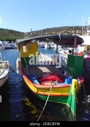 Brightly painted fishing boats anchored in the harbour of sleepy seaside village   Porto Pollo, Gulf of Valinco, Corsica France