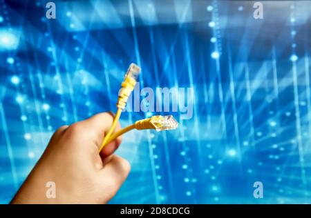 yellow network cable with rj-45 connector on a blue background Stock Photo