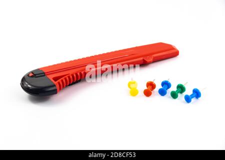 Stationery set clerical knife and pins, on white isolated background Stock Photo