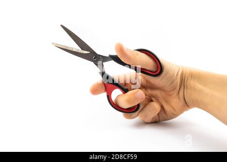 Man holding stationery scissors in hand, on white isolated background Stock Photo