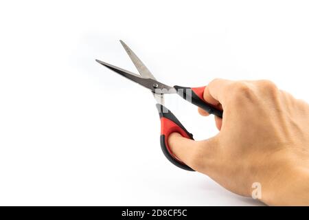 Man holding stationery scissors in hand, on white isolated background Stock Photo