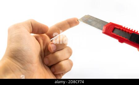 Open clerical knife, danger of cutting yourself in classroom at school, on white isolated background Stock Photo