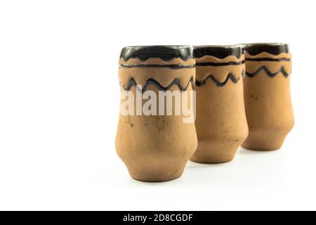 Set of clay shot glass, bowl, old dishes, antiques on white isolated background Stock Photo