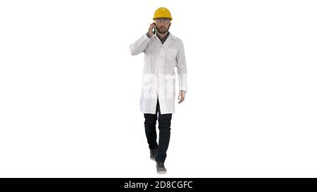 Confident male engineer wearing helmet on call on white backgrou Stock Photo