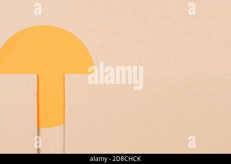 Brown blank cardboard background with orange round color paper card. Top view Stock Photo