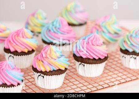 Step by step. Scooping batter with a cupcake scoop to make unicorn  chocolate cupcakes with buttercream frosting Stock Photo - Alamy