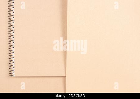 Craft paper background with spiral notebook. Abstract minimal background Stock Photo