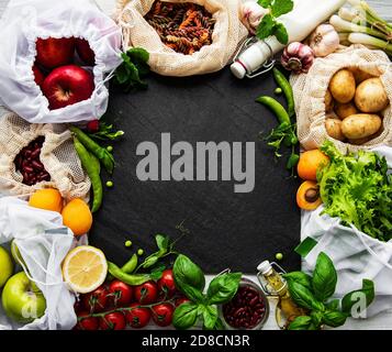 Zero waste shopping and sustanable lifestyle concept, various farm organic vegetables, grains, pasta and fruits in reusable packaging supermarket bags Stock Photo
