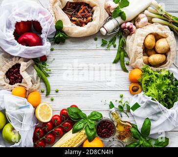 Zero waste shopping and sustanable lifestyle concept, various farm organic vegetables, grains, pasta and fruits in reusable packaging supermarket bags Stock Photo