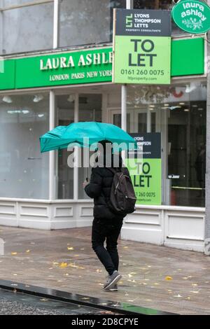 Preston, Lancashire.  Uk Weather. 29th October 2020. Shopping must go on in the city centre on a wet rainy day with heavy downpours, and merging showers.  Preston retail sector has been heavily affected by Covid 19 regulations with several businesses closing in the high street.   Credit; MediaWorldImages/AlamyLiveNews Stock Photo