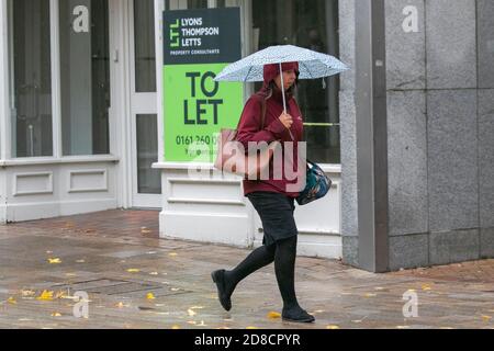 Preston, Lancashire.  Uk Weather. 29th October 2020. Shopping must go on in the city centre on a wet rainy day with heavy downpours, and merging showers.  Preston retail sector has been heavily affected by Covid 19 regulations with several businesses closing in the high street.   Credit; MediaWorldImages/AlamyLiveNews Stock Photo