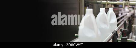 White plastic Bottles transfer on Automated conveyor systems industrial automation for package, free space on left side for text. Stock Photo