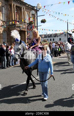 Irvine, Ayrshire,  Scotland. UK, Festival of Marymass dates back to the Middle Ages & the rich pageantry of this fair draws old Irvinites home in August each year. In the 1920s interest was flagging credit is given to the then Provost of the Royal Burgh of Irvine, Peter S Clark, for first proposing that a Marymass Queen be chosen and crowned as a part of the ceremony.A meeting took place with the Captain of the Carters as a result 4 local school children are chosen as Queens, & 2 page boys,.A crowning ceremony at the TownHouse followed by a parade to Ivine Moor/ All floats are horse drawn Stock Photo