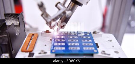 Technological process of soldering and assembly chip components on pcb board. Automated soldering machine inside at industrial Stock Photo