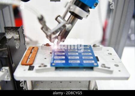 Technological process of soldering and assembly chip components on pcb board. Automated soldering machine inside at industrial Stock Photo