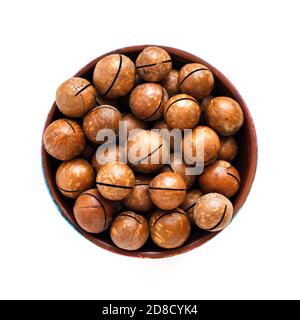 macadamia nuts in bowl on white background, top view Stock Photo