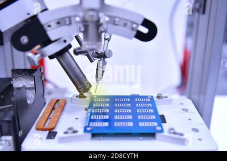 Technological process of soldering and assembly chip components on pcb board. Automated soldering machine inside at industrial Stock Photo