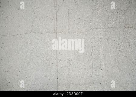 Old cracked grey concrete wall, weathered building background. Stock Photo