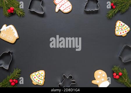 Forms for cooking and christmas cookies on black background with copy space Stock Photo