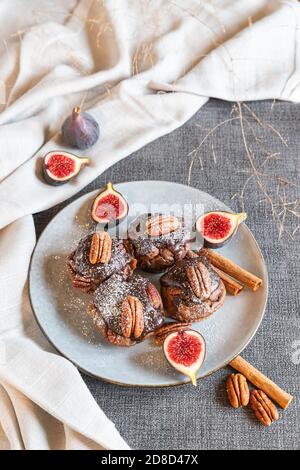 chocolate muffins with pecan and figs on gray background Stock Photo