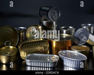 Different types of cans with prepared foods for consumption, vegetables, fish and meat Stock Photo