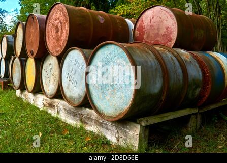 Wietze, Germany, September 10., 2020: Old empty oil barrels on a solid wood Euro pallet Stock Photo