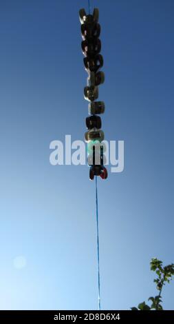 Clothes pins on a clothes line rope - plastic pegs holding nothing. Stock Photo