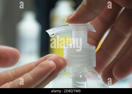 Man sanitizing hand with alcohol gel sanitizer disinfectant dispenser,corona virus covid19 pandemic disease Stock Photo