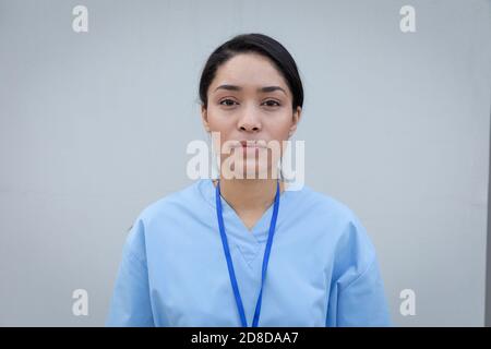 Portrait of female health professional against grey background Stock Photo