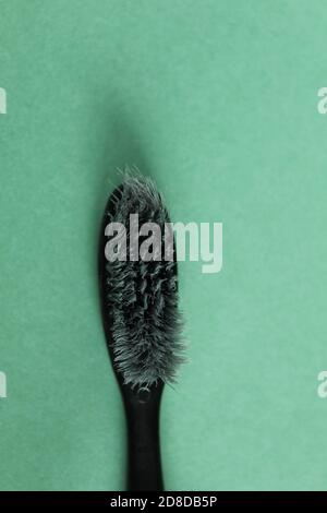 toothbrush black gray old used on a green grass background copy space Stock Photo