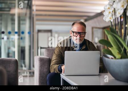 Mature man looking fixedly at his laptop Stock Photo