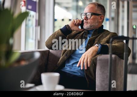 Grey-haired Caucasian man making a phone call Stock Photo